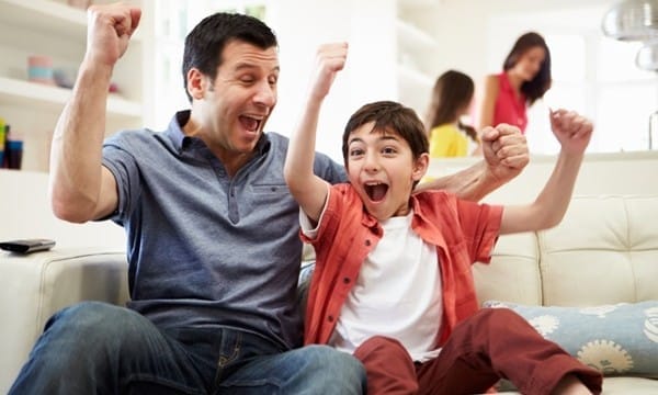 Father And Son Watching Sports On TV